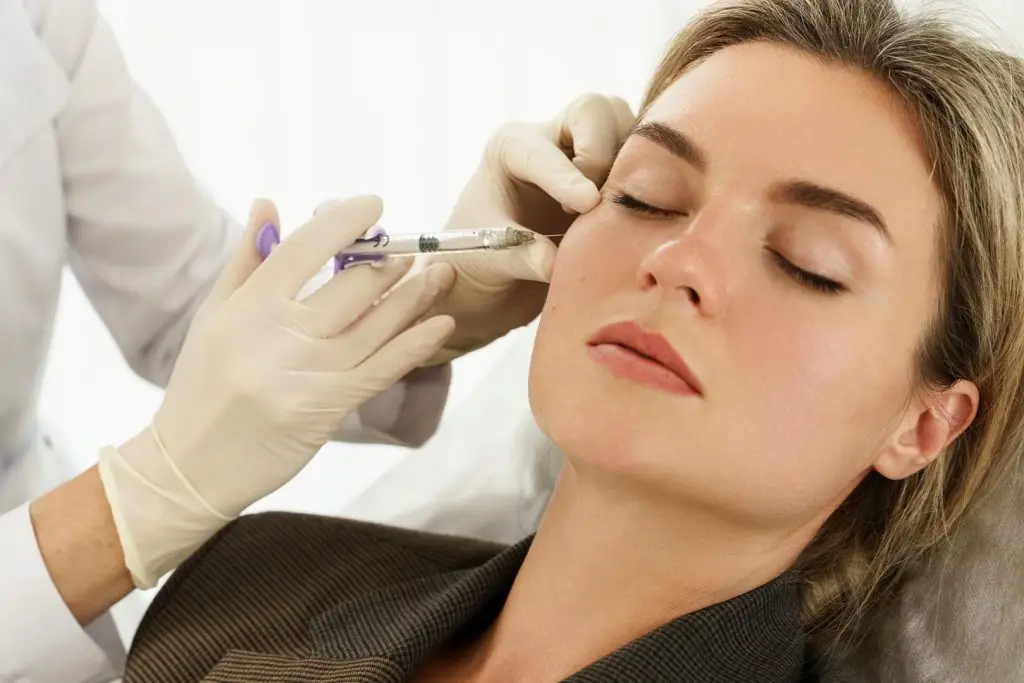 young Woman during Facial Filler Injections in Aesthetic Medical Clinic
