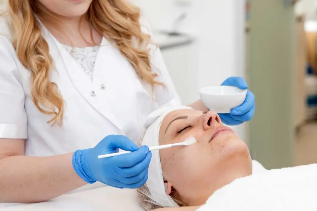 woman getting professsional chemical peel facial treatment